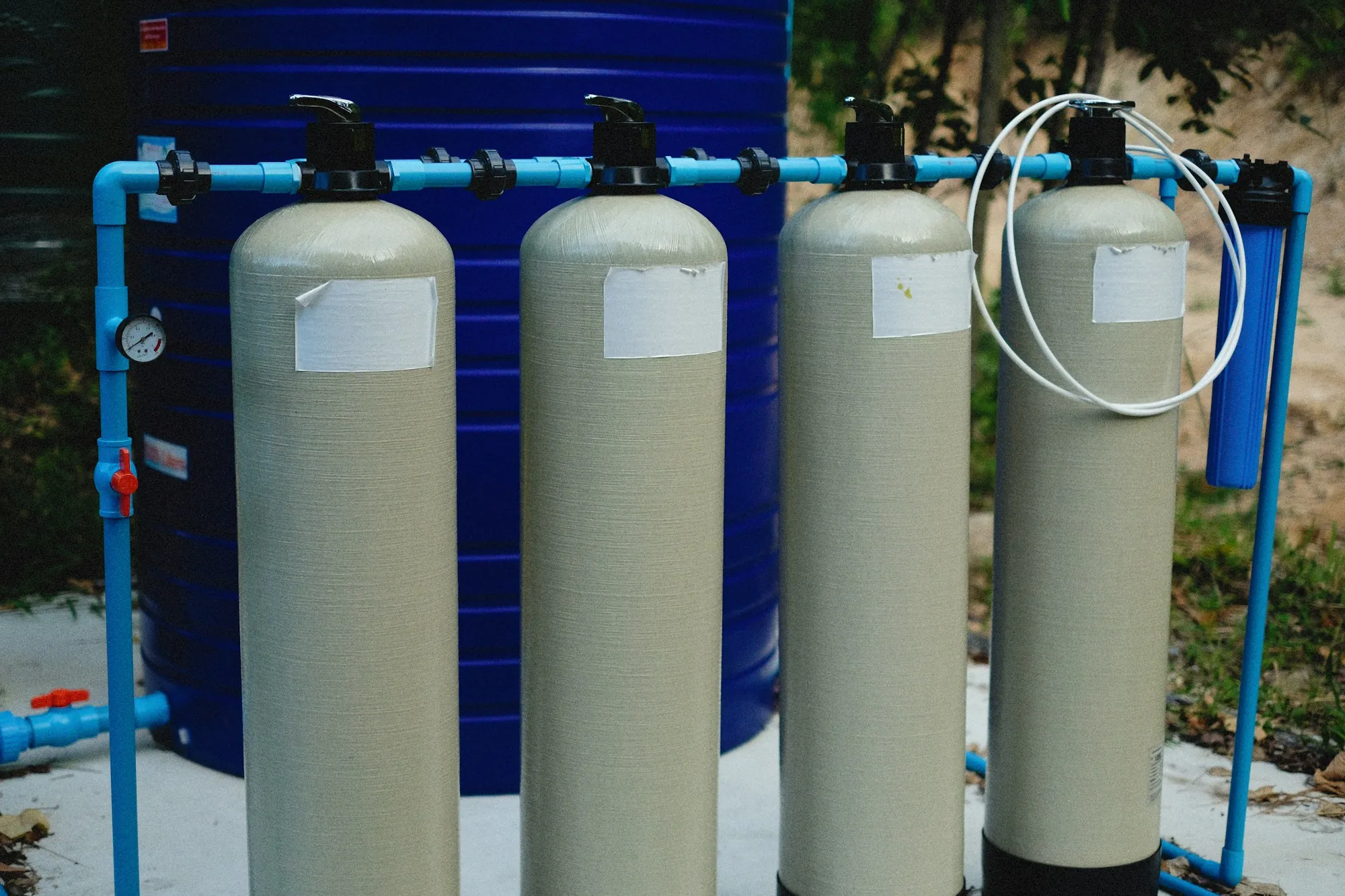 Row of filtration and softening tanks plumbed together